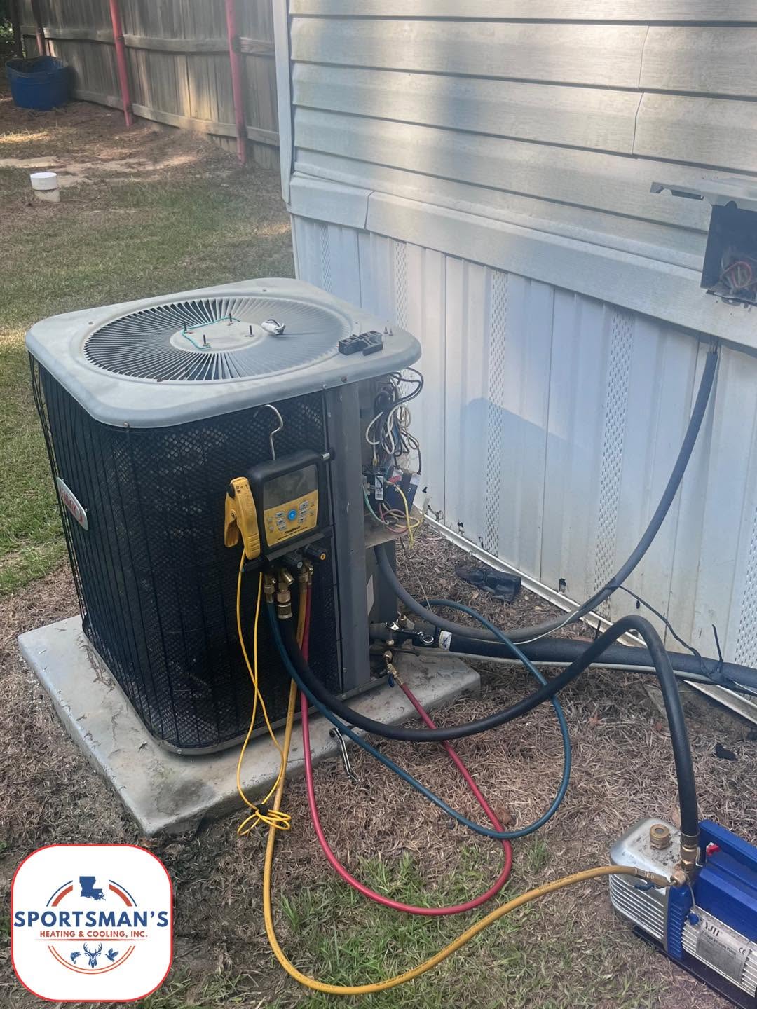 Outdoor condenser connected to service gauges and hoses