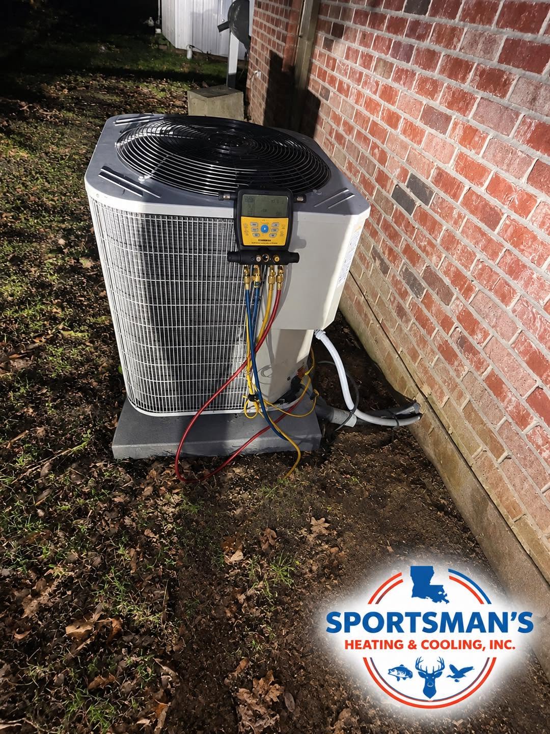 Outdoor HVAC condenser beside a brick wall